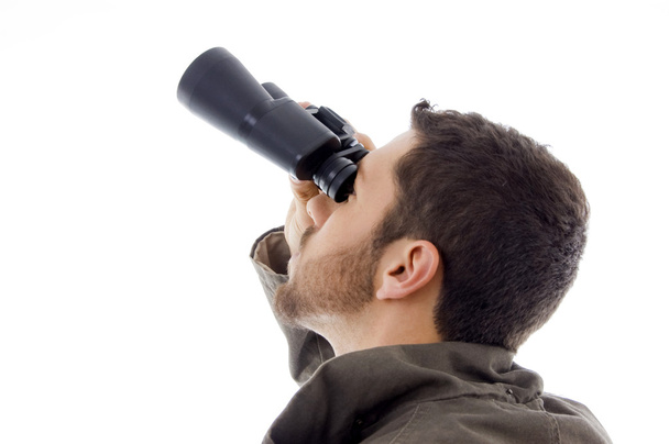 Hispanic man looking through binoculars - Zdjęcie, obraz