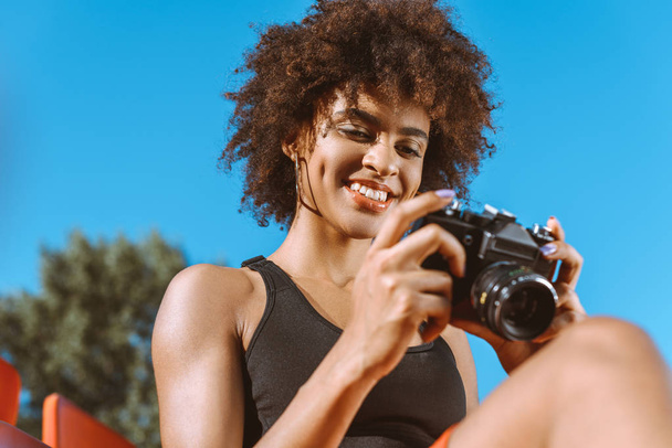 Athletic african-american woman with camera - Photo, Image