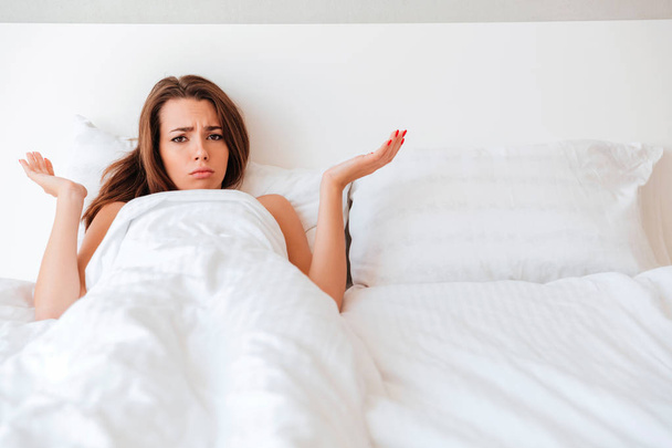 Frustrated upset woman lying in her empty bed - Fotografie, Obrázek