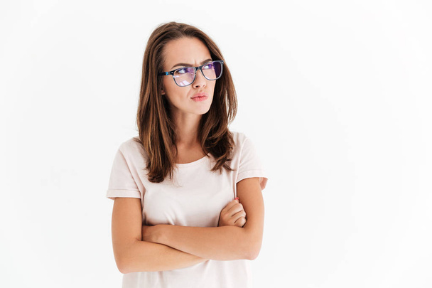 Serious brunette woman in eyeglasses with crossed arms - Photo, image
