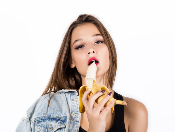 Young sensual woman eating banana on white background. provocation concept - Fotoğraf, Görsel