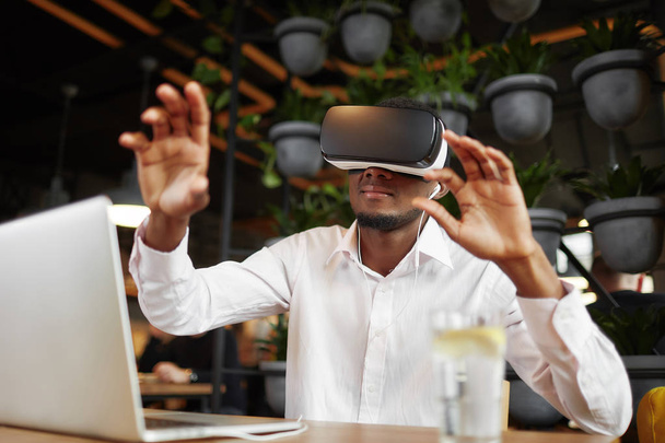 African man in glasses of virtual reality pointing in air. - Fotó, kép
