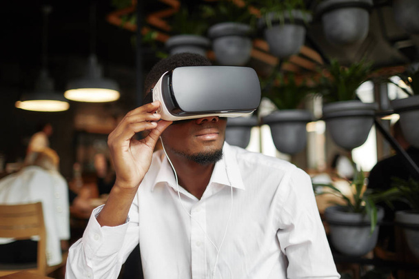 African man wearing in glasses of virtual reality watching video. - Fotoğraf, Görsel