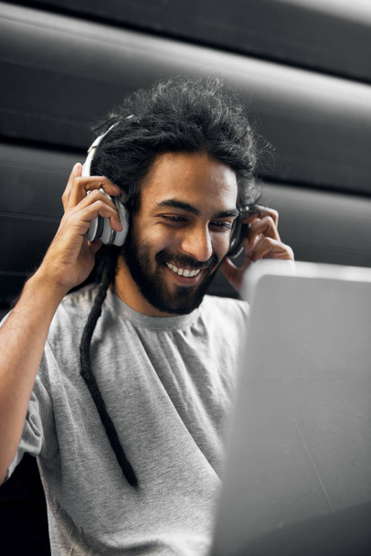 young man with dreadlocks using laptop - Photo, Image