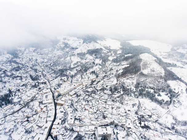 Aerial view of small town with hills in winter. - Zdjęcie, obraz