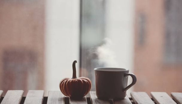 White cup of coffee and pumpkin on table - Photo, Image