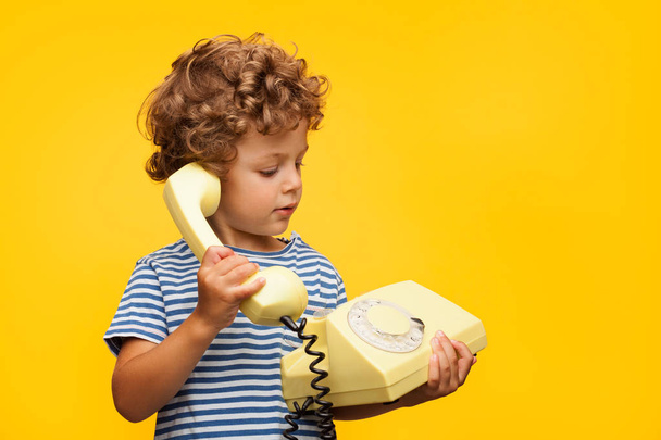 Boy talking obsolete phone - Foto, Imagem