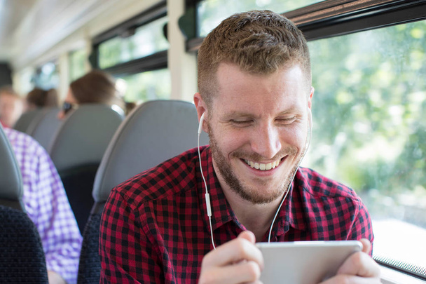 Man Watching Movie On Mobile Phone During Journey To Work - Photo, image