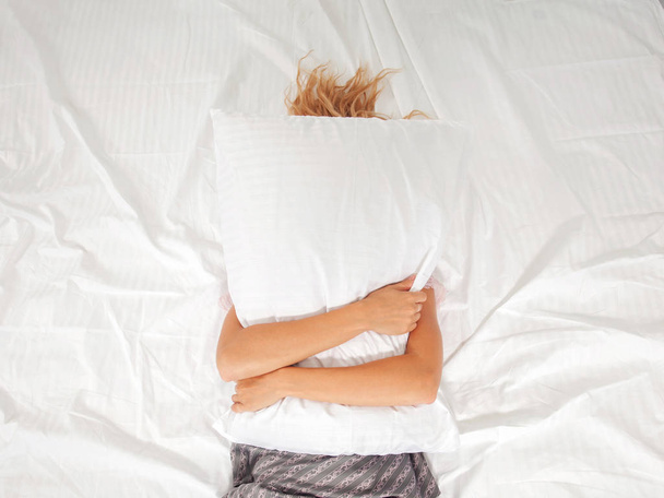 Tired woman on the bed - Fotó, kép