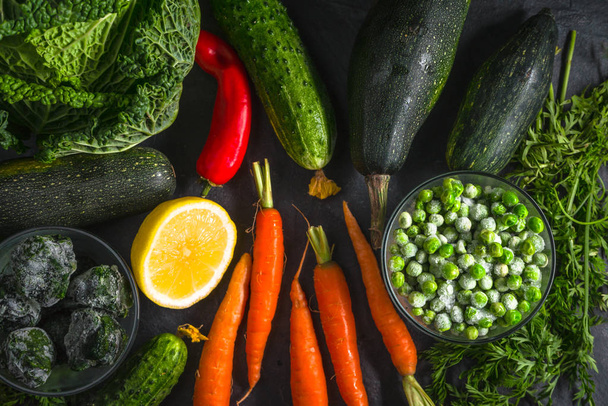 Carrots, lemon and green vegetables on the table - Foto, Imagem