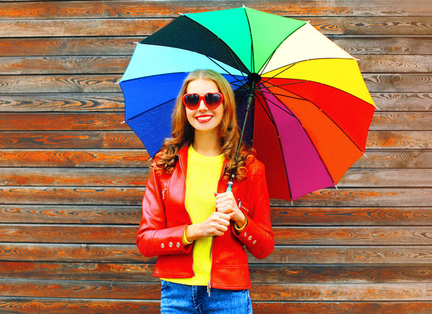 Fashion smiling woman with colorful umbrella in autumn day over  - Foto, imagen