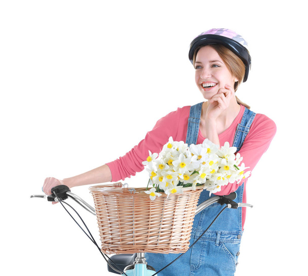 Young girl with bicycle and basket of flowers - Photo, Image