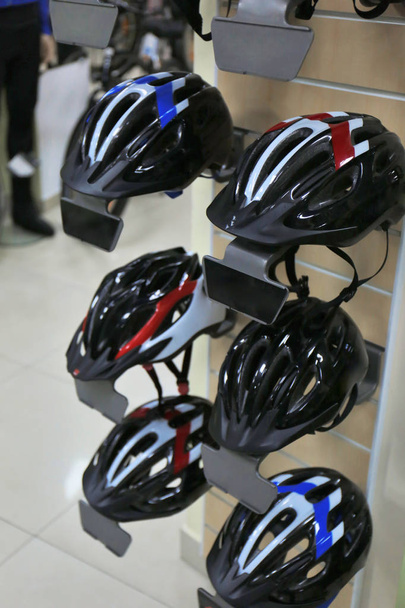 Stand with helmets in bicycle shop - Photo, Image