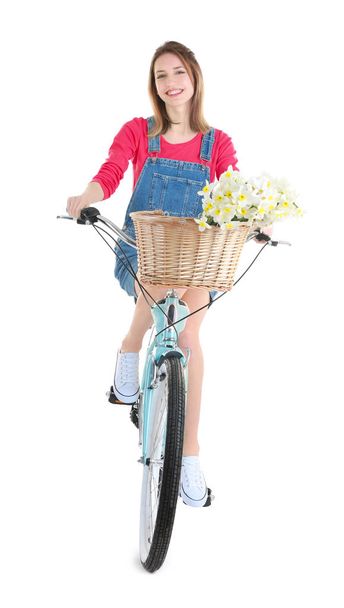 Young girl with bicycle and basket of flowers - Foto, imagen