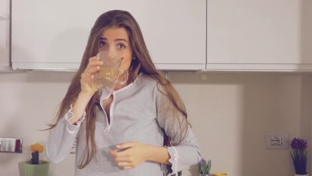 Woman dancing happy in kitchen in pajamas  - Video