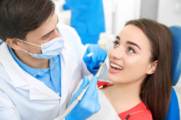 Dentist drilling patient's teeth in clinic - Foto, immagini