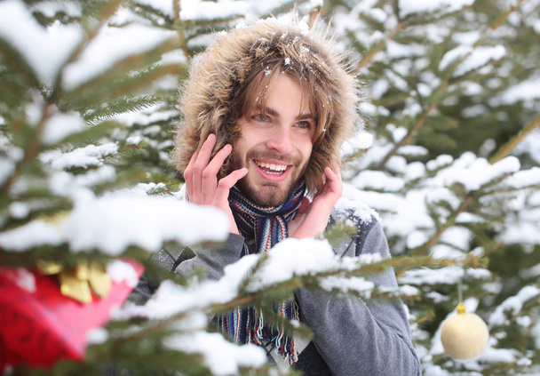Happy macho with bearded face in snow forest - Fotoğraf, Görsel
