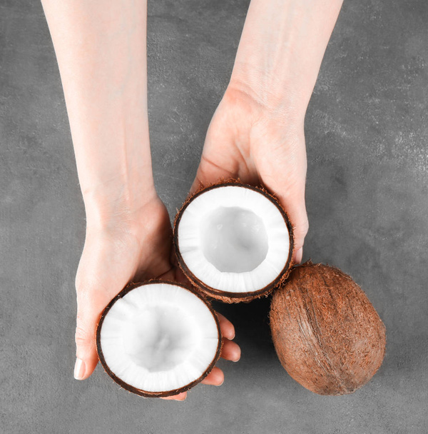 Female hands with coconuts  - Fotografie, Obrázek