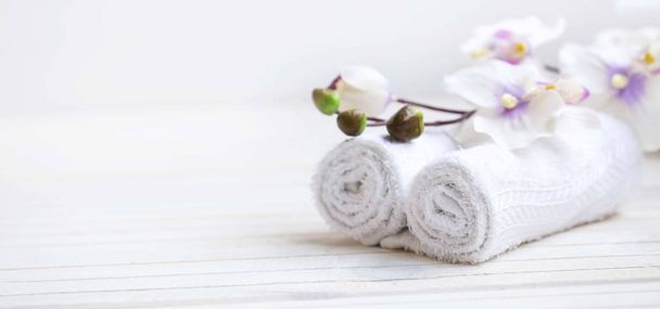 SPA setting with bath towels and orchid flower, selective focus - Photo, image