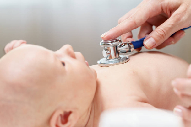 doctor listening heartbeat of newborn baby by stethoscope - Foto, afbeelding