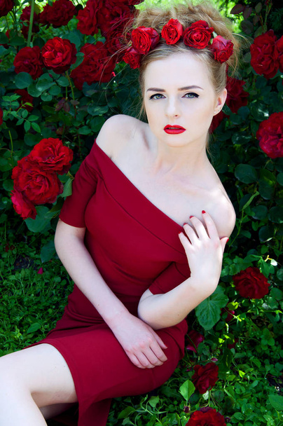 Lady vamp in crimson red dress with naked shoulders and red rose - Photo, Image