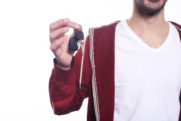 Close up of young man holding car keys. - Foto, afbeelding
