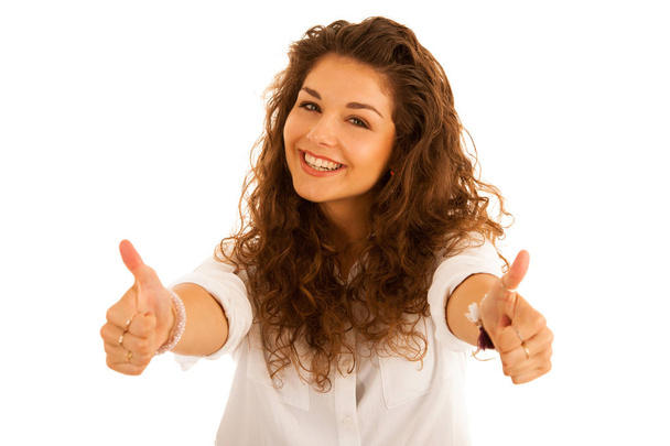 Attractive young happy woman gesturing success showing thumb up - Photo, Image