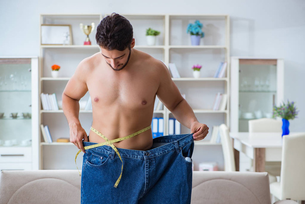 Man in oversized pants in weight loss concept - Φωτογραφία, εικόνα