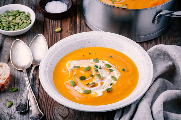 Homemade butternut squash soup with cream and seeds  - Photo, Image