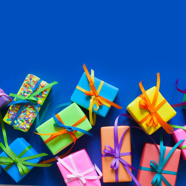 Colored holiday gifts. Blue background. - Photo, Image