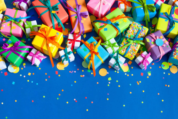 Colored holiday gifts. Blue background. - Foto, imagen