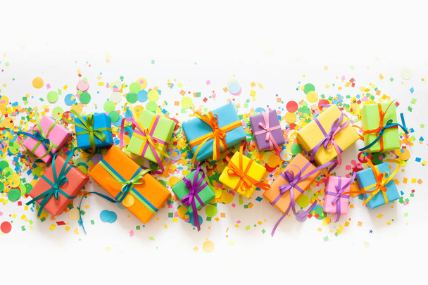 Colored gift boxes with colorful ribbons. White background. Gift - Foto, Imagem