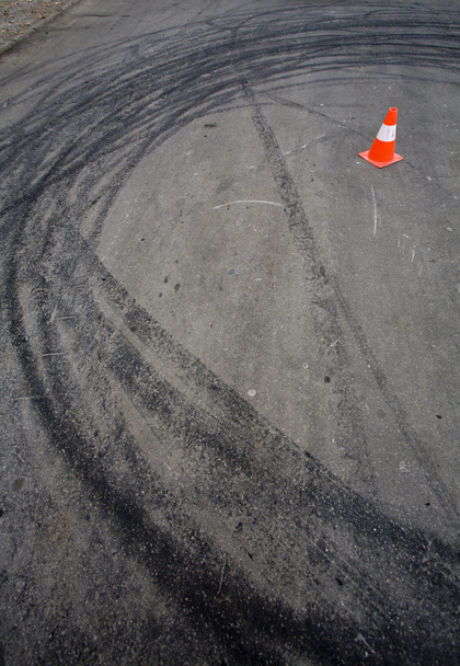 Orange traffic cone and skid marks - Photo, Image