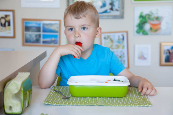 Child boy eating fresh vegetable salad - Фото, изображение