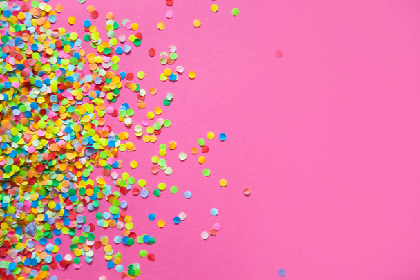 Frame made of colored confetti. Pink background.  - 写真・画像