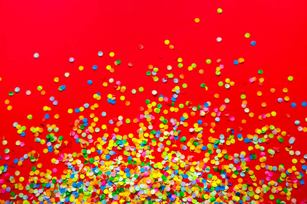 Frame made of colored confetti. Red background.  - Foto, imagen