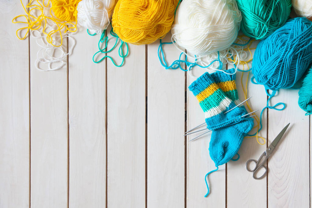 A woman knits knit socks with children's knitting needles. Strip - Fotó, kép