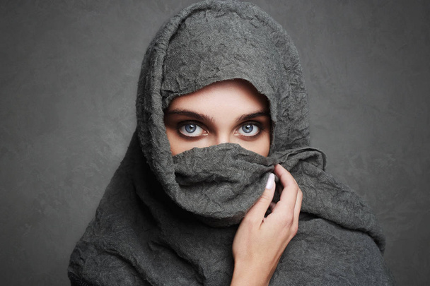 beautiful arab woman covers her face - 写真・画像
