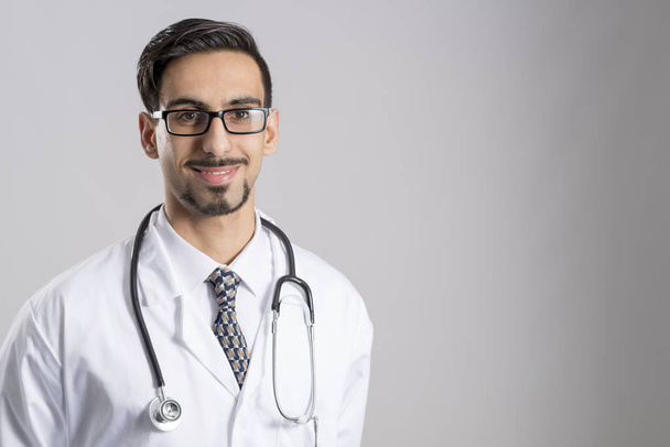 Young Doctor in Uniform with Stethoscope Around Neck Copy Space - Фото, зображення
