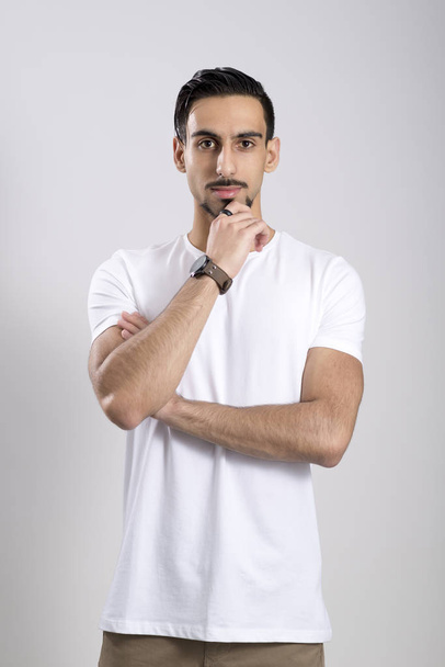 Young Man in White Shirt and Khaki Pants Over White Background - Fotografie, Obrázek