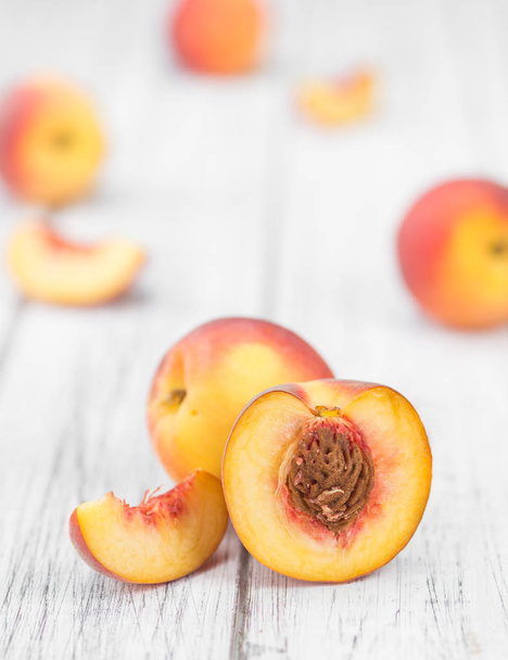 Peaches on an old wooden table  - Foto, imagen