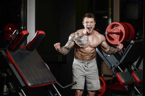 Strong and handsome athletic young tattoo man with muscles  - Foto, imagen