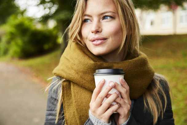 blond woman with coffee in park - Φωτογραφία, εικόνα