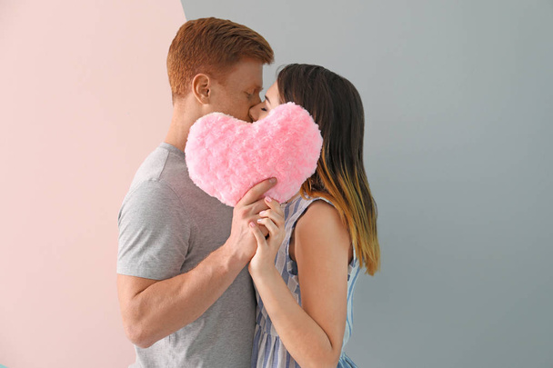 Lovely couple with pink heart on color background - Foto, Imagen
