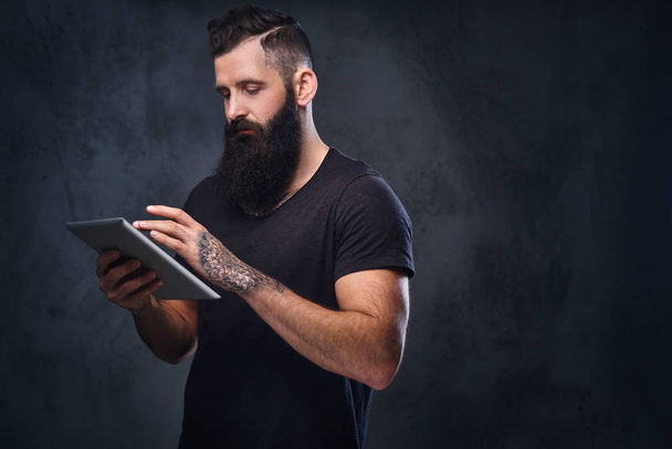 Hombre barbudo usando tableta de plata
  - Foto, imagen