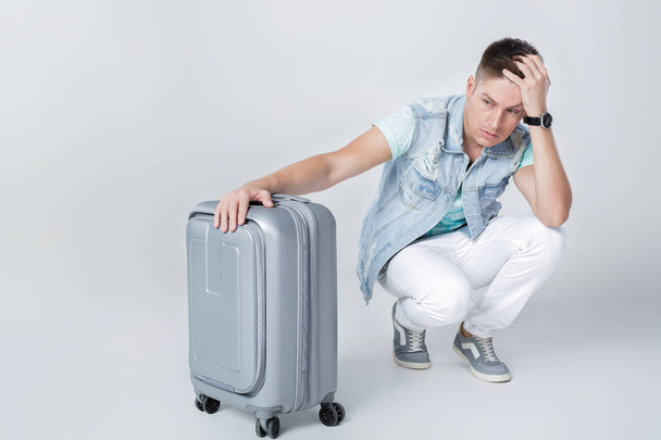 young man in blue shirt with suitcase - Fotó, kép