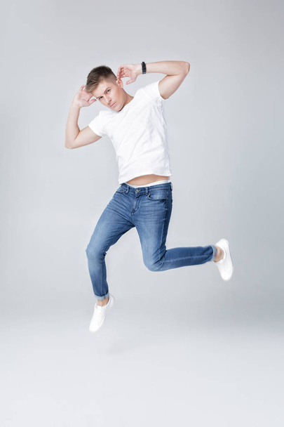 handsome man in jeans and jacket jumping - Zdjęcie, obraz
