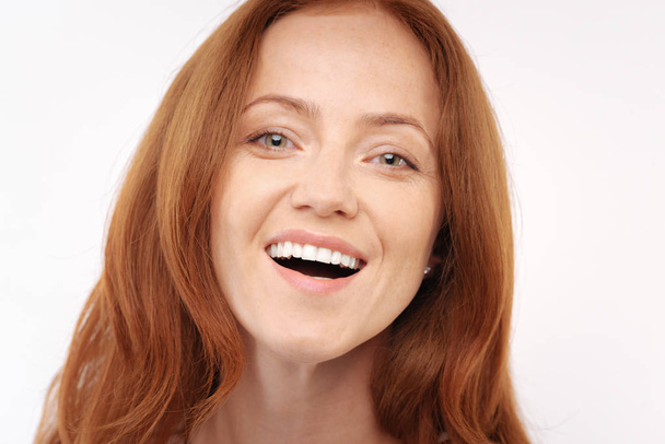Portrait of a smiling ginger-haired woman - Photo, Image
