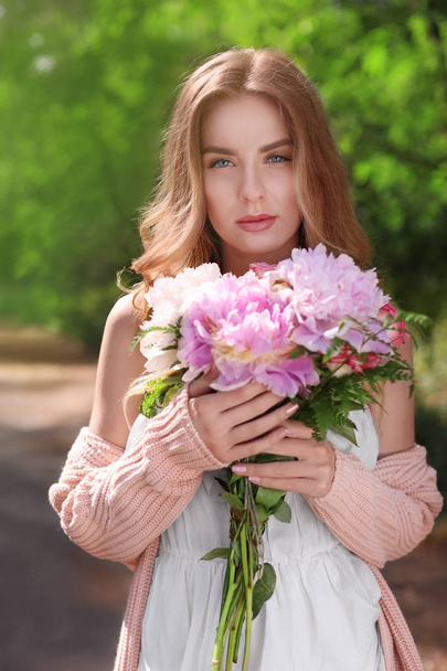 young woman with bouquet of peonies - Fotoğraf, Görsel
