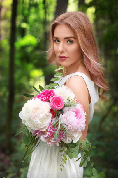 young woman with bouquet of peonies - Fotoğraf, Görsel